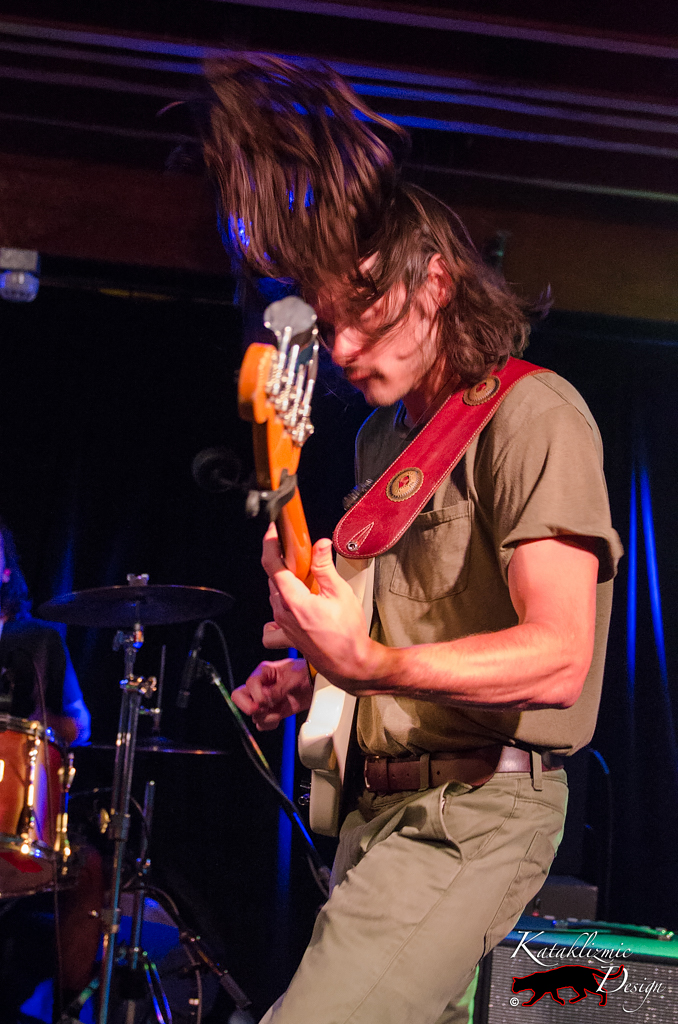 Dalton Allison holding bass with hair flying