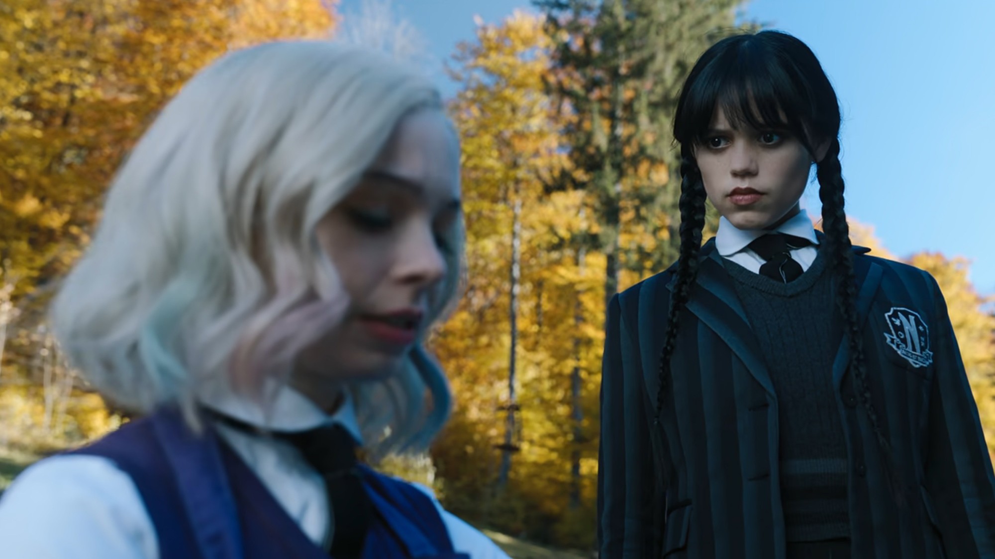 Wednesday Addams stares intensely at Enid Sinclair.