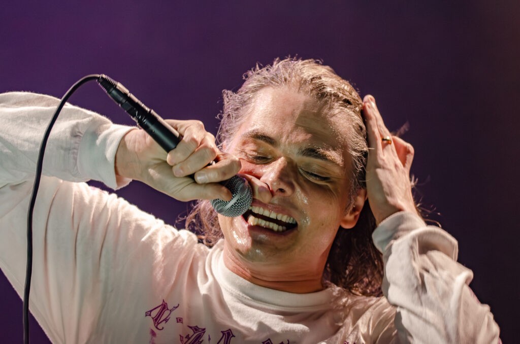 Closeup of Gerard Way of Chemical Romance singing live with an emotive facial expression