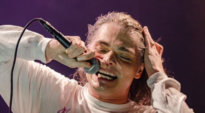 Closeup of Gerard Way of Chemical Romance singing live with an emotive facial expression