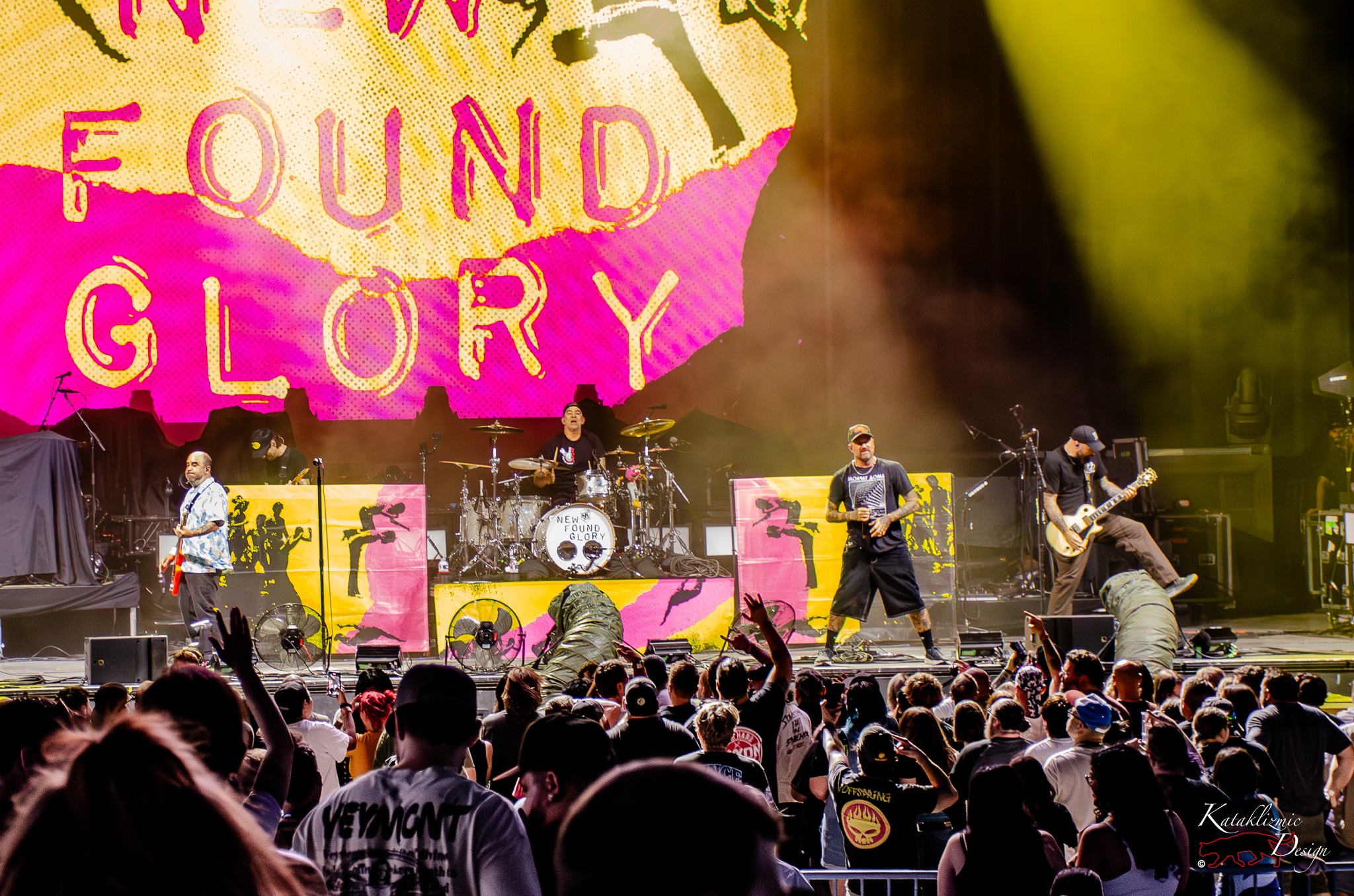 New Found Glory performs under neon pink and yellow visuals as a cheering Phoenix crowd looks on at Talking Stick Resort Amphitheatre during the Supercharged Tour.