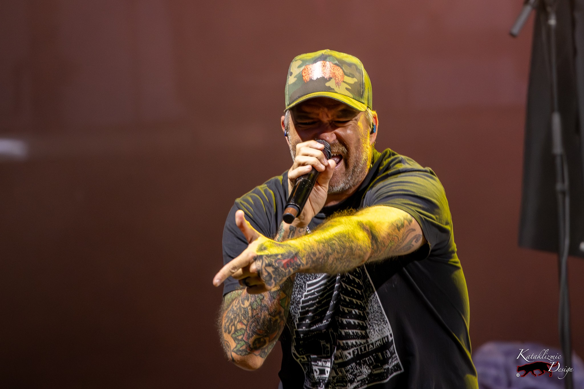 Close-up of Jordan Pundik (vocals), New Found Glory pointing a finger gun