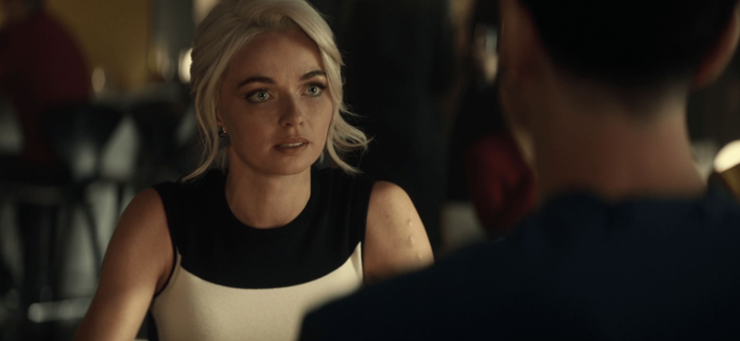 Chapel looks across the table at Spock, her expression firm but empathetic, in a dimly lit bar setting.