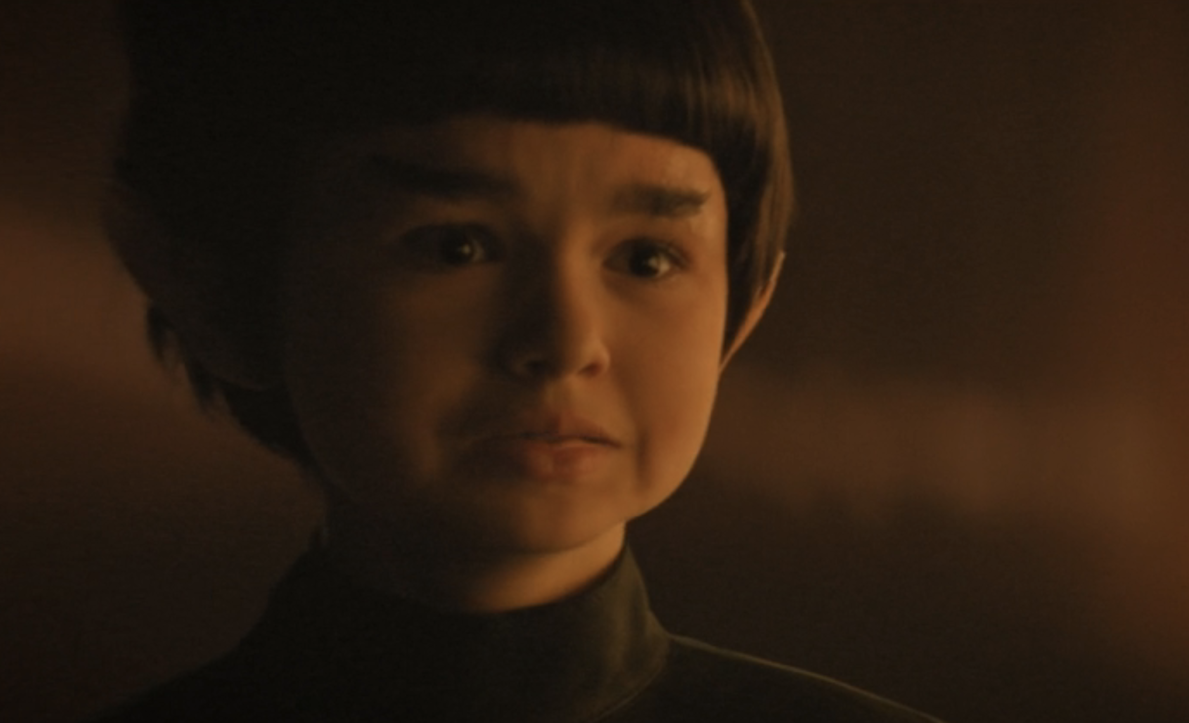 A young Spock in Star Trek: Discovery looks distressed, his face tense and eyes welling with emotion.