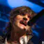 BOYS LIKE GIRLS lead singer Martin Johnson performing at Marquee Theatre, singing into a microphone under blue stage lights.