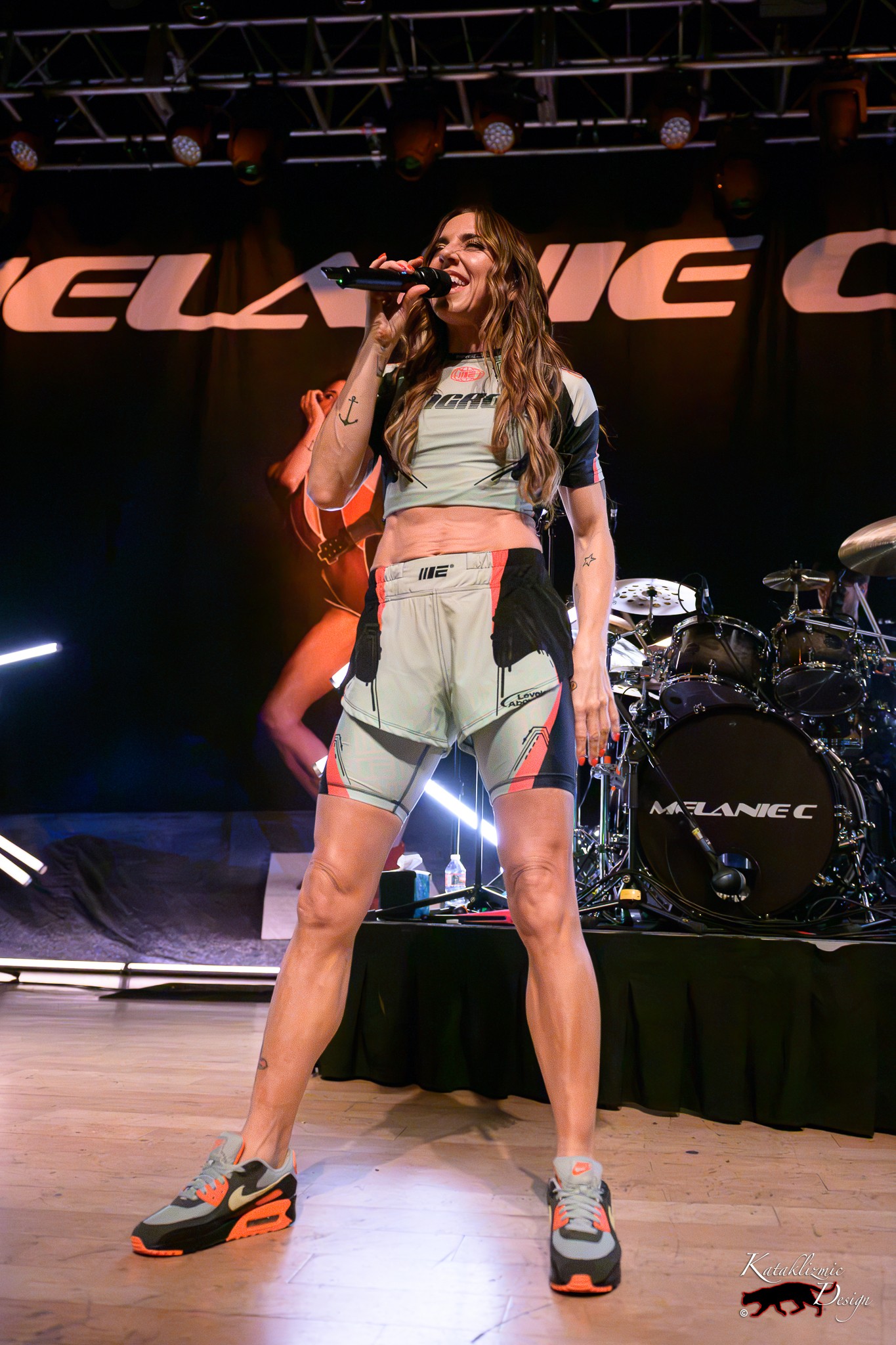 Melanie C smiles onstage in a sporty two-piece outfit during The Melanie C World Tour at House of Blues San Diego.