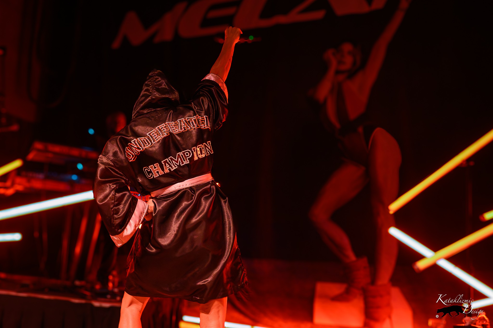 Melanie C raises a fist with “Undefeated Champion” visible across the back of her boxing robe at House of Blues San Diego.