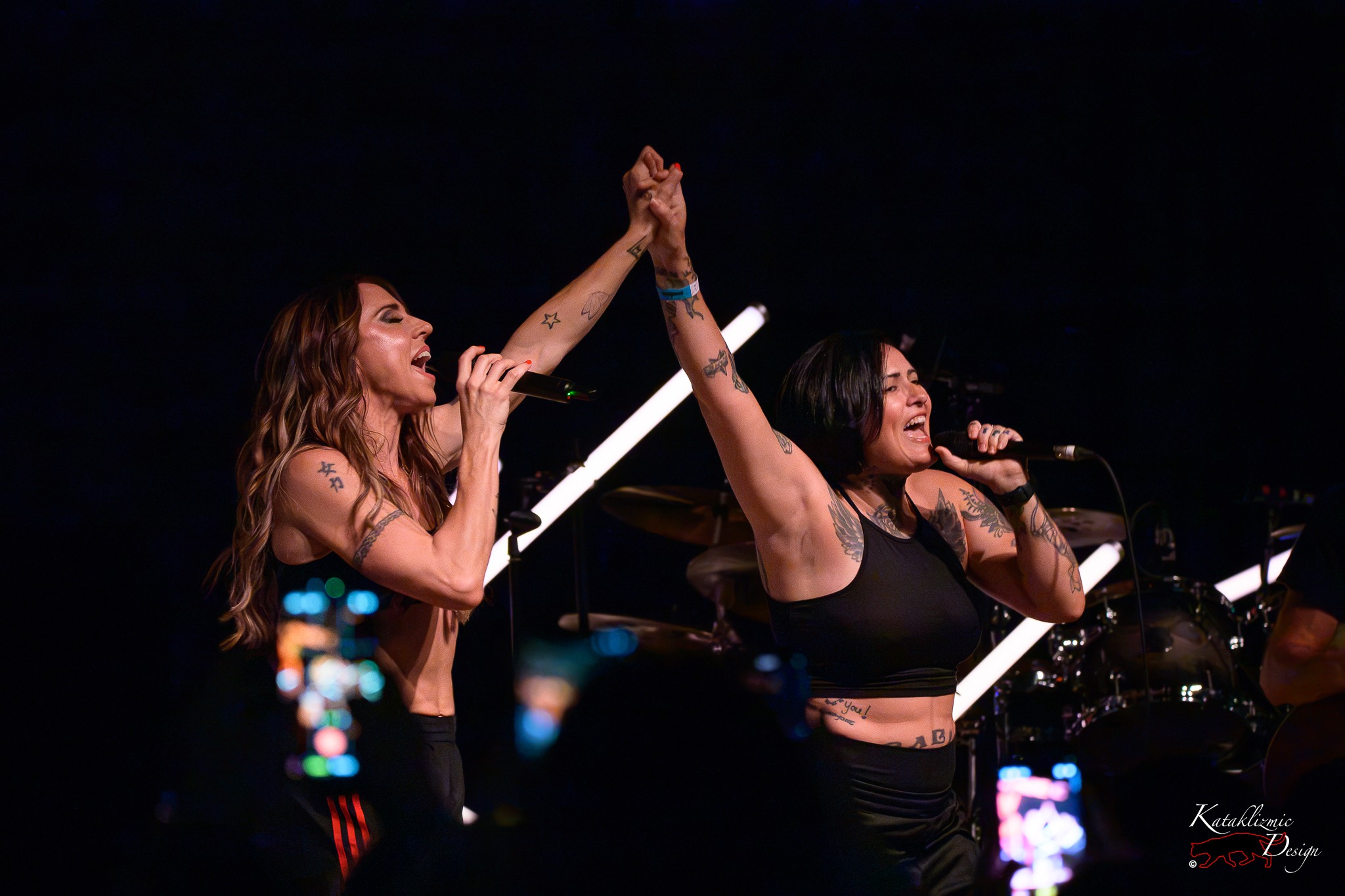 Melanie C holds hands with an audience member as they sing together during “Never Be the Same Again” at House of Blues San Diego.