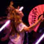 Melanie C whips her hair while holding a bright pink fan during The Melanie C World Tour at House of Blues San Diego.