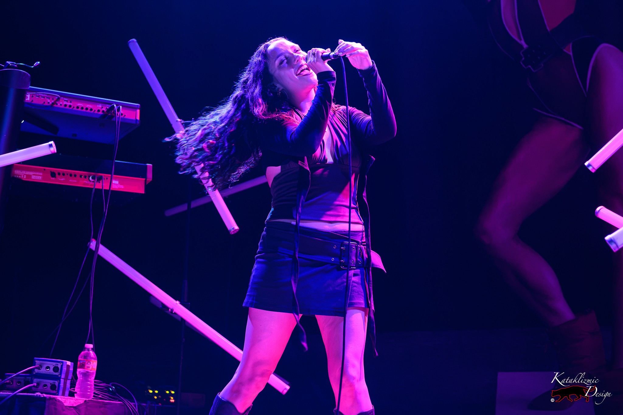 Sur Back performs under vivid purple and pink stage lights at House of Blues San Diego while opening for Melanie C.